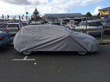 car cover on car sideview with cars in background 
